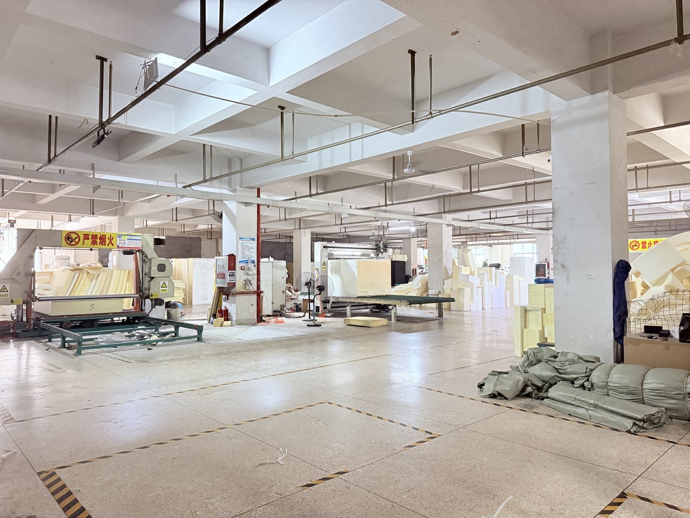 Foam processing workshop with cutting equipment